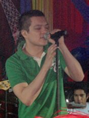 OPM singer Bamboo Mañalac singing into a microphone on stage