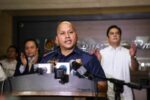 Ronald dela Rosa speaking at a podium in police uniform during his time as PNP chief