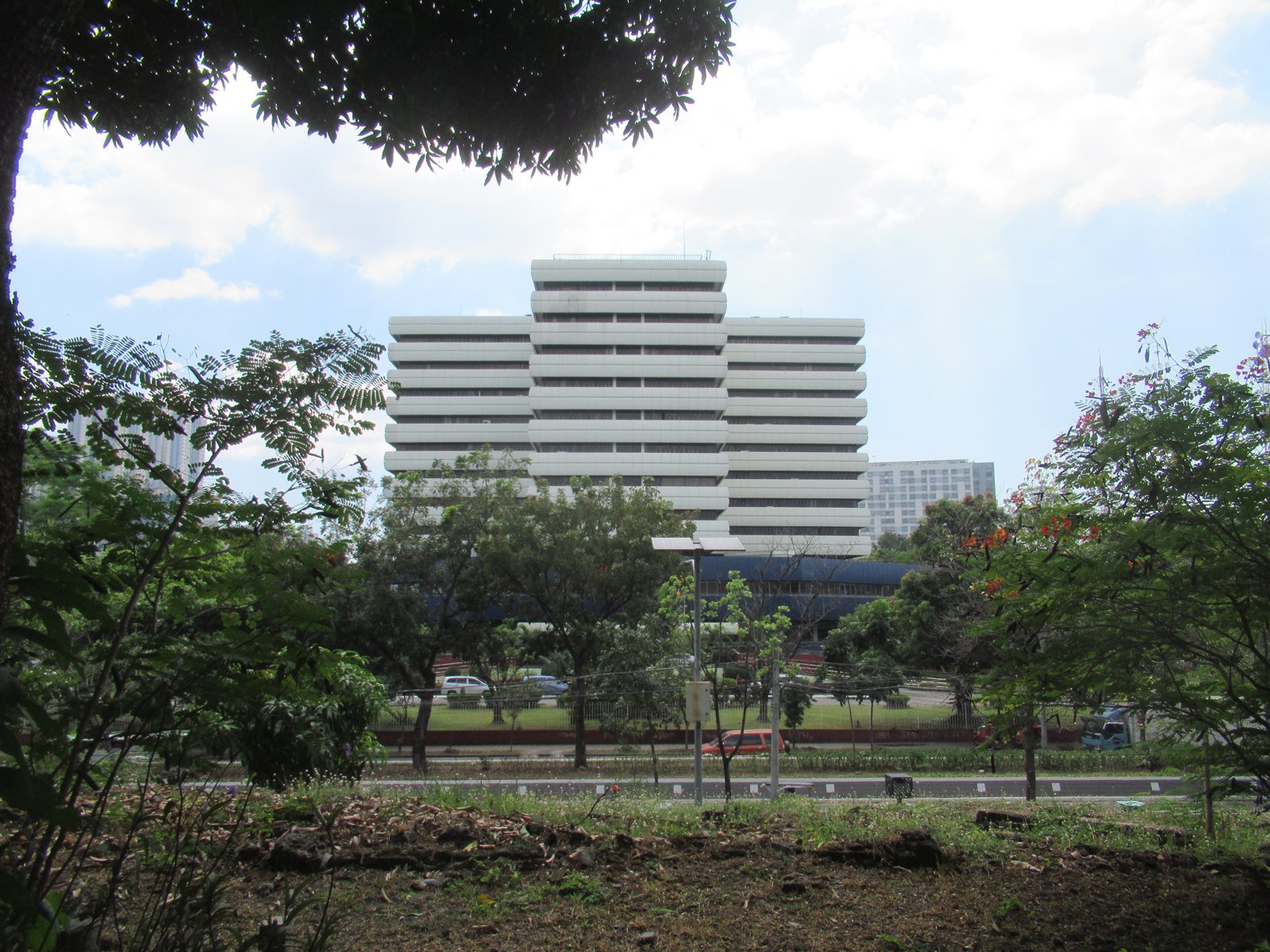 Bureau of Internal Revenue National Office building in Quezon City seen behind trees