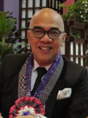 TV host Boy Abunda smiling in a dark suit
