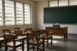 Empty Philippine public school classroom with a laptop showing an online class