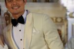 Actor Dingdong Dantes smiling in a white tuxedo jacket and black bow tie