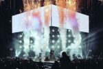 Regine Velasquez performing on a concert stage with pyrotechnics and stage lights