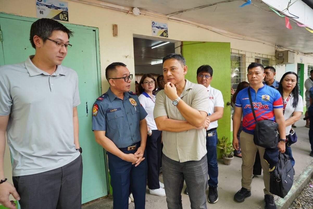 Education Secretary Sonny Angara with school and local officials during a DepEd school visit