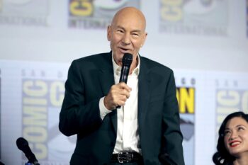 Patrick Stewart speaking into a microphone at Comic-Con