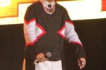 Vice Ganda with pink hair performing on stage holding a microphone